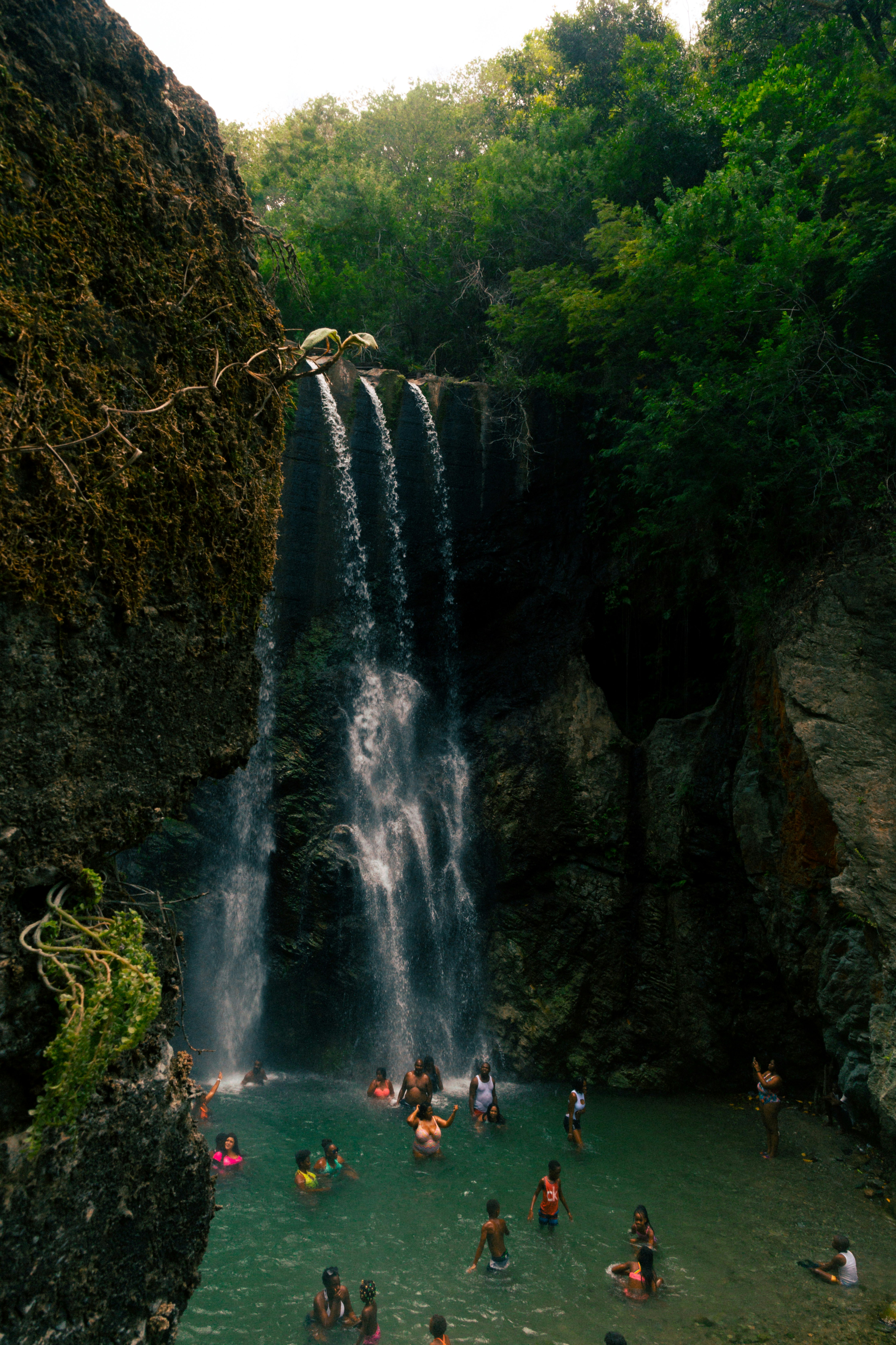 people standing near waterfalls during daytime