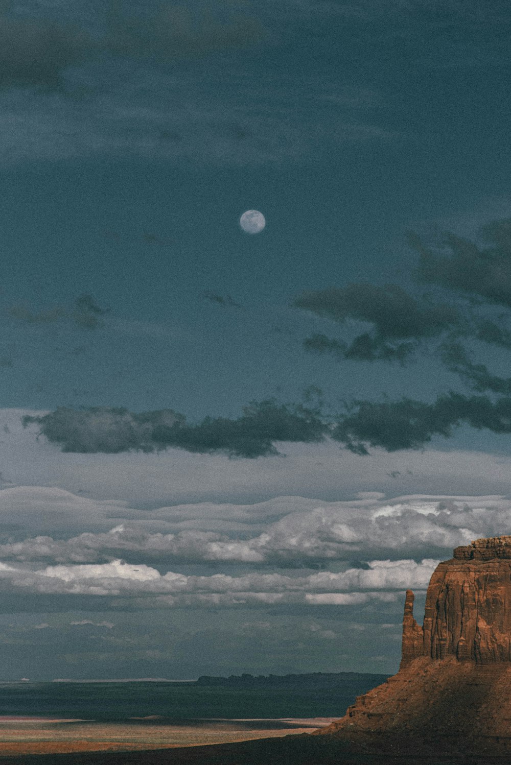 brown rock formation under blue sky and white clouds during daytime