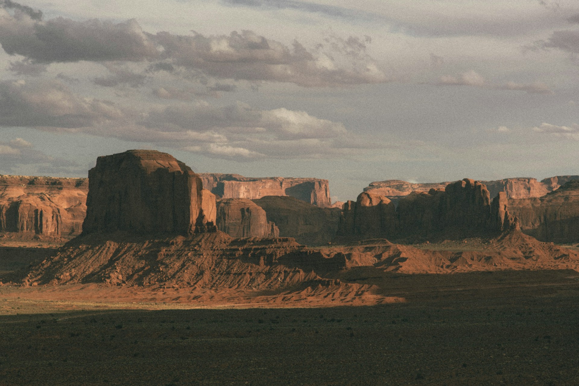 brown rock formation under white clouds during daytime