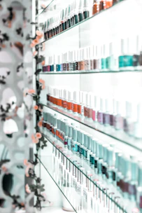 clear glass bottles on glass shelf