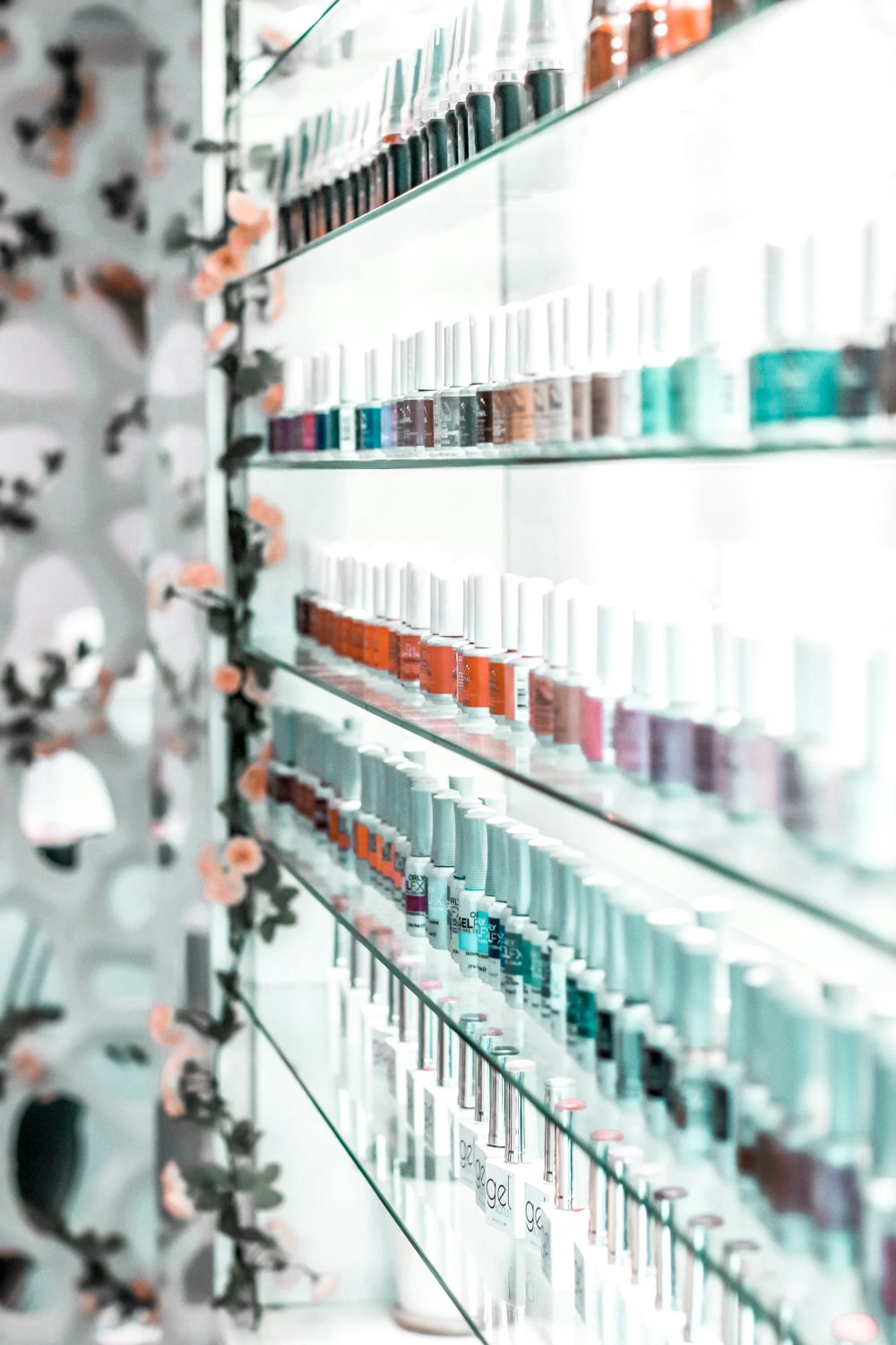 clear glass bottles on glass shelf