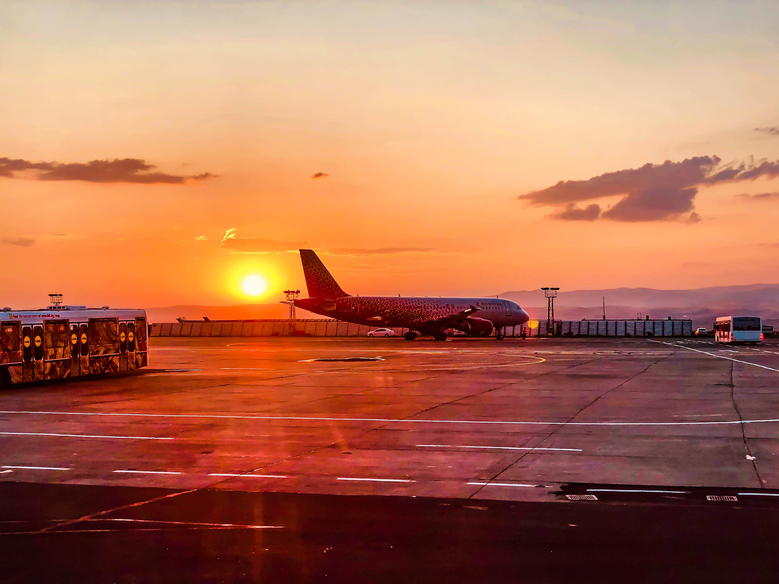Passenger jet on an airport apron at sunset, the moment a Canadian traveller's phone switches to roaming
