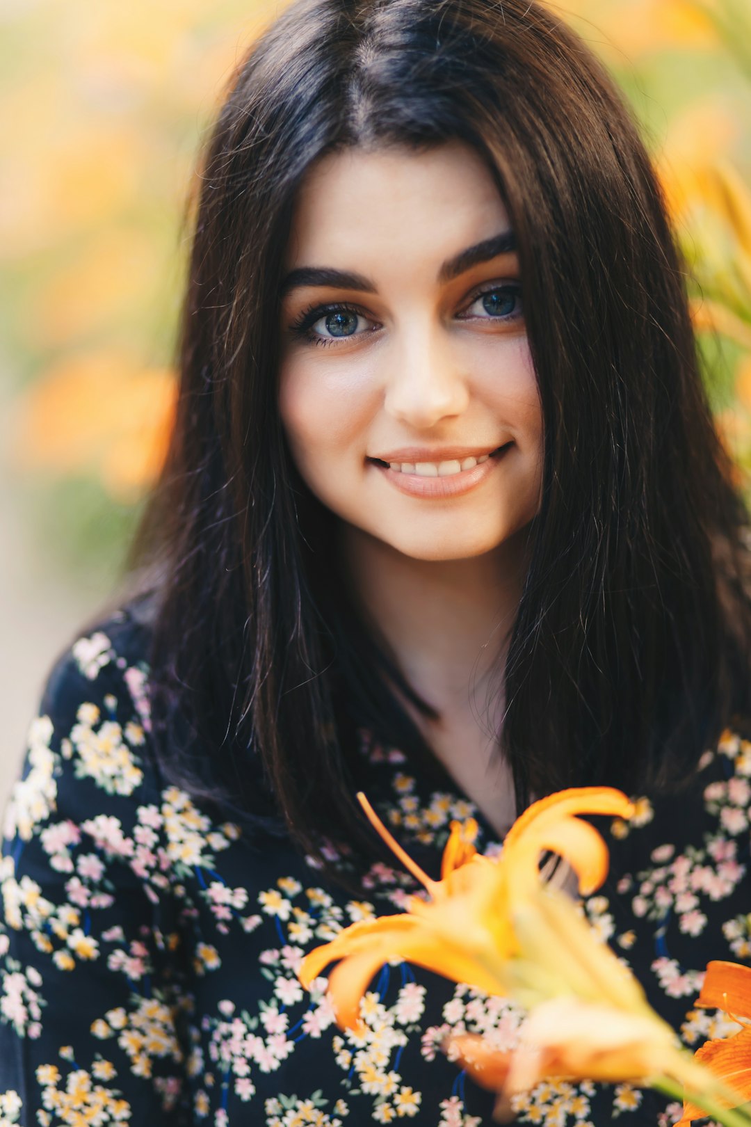 woman in black and white floral shirt smiling