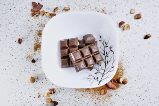 Assorted handmade chocolates arranged artfully on a rustic plate.