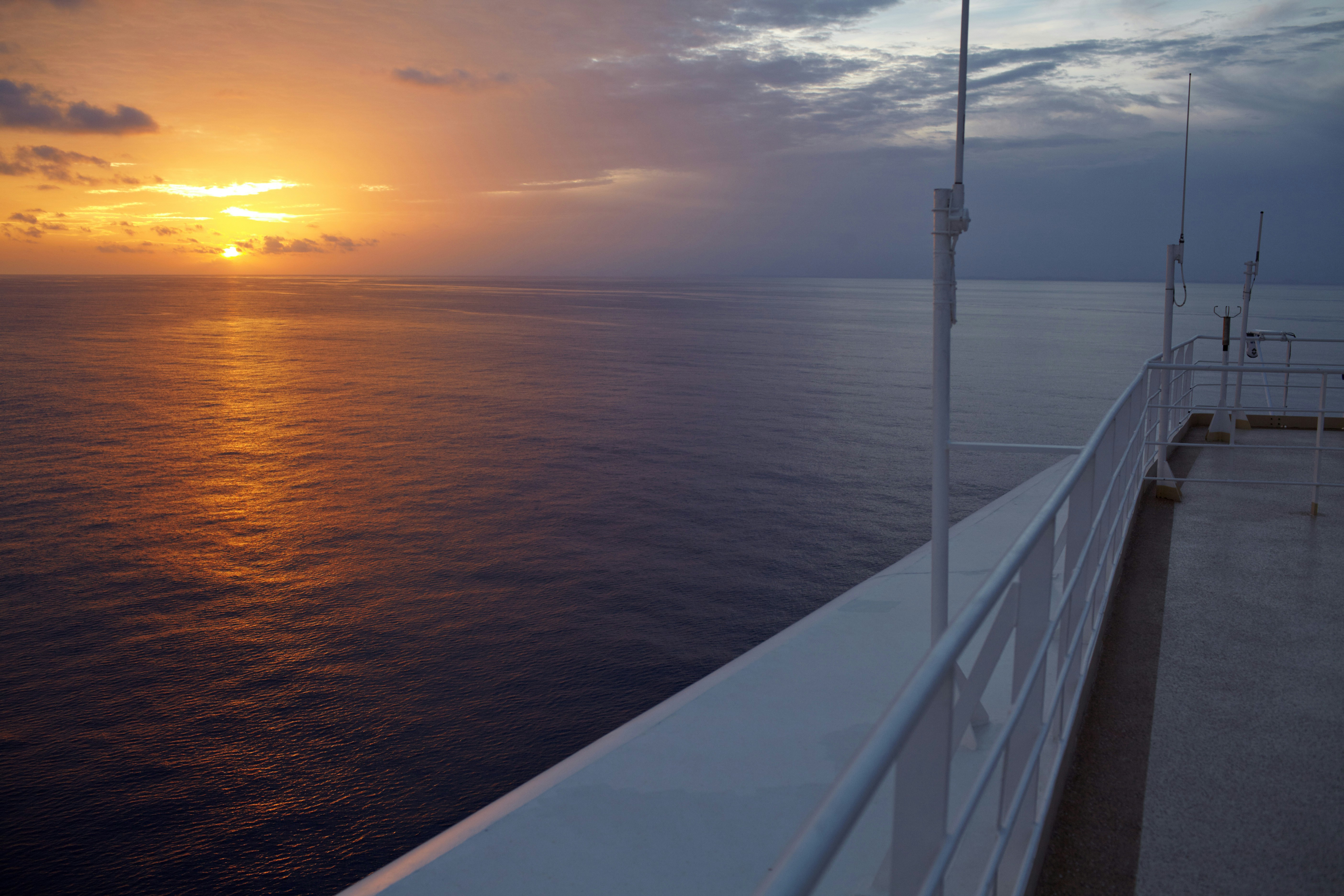 white metal railings near body of water during sunset, Midnight in Alaska.