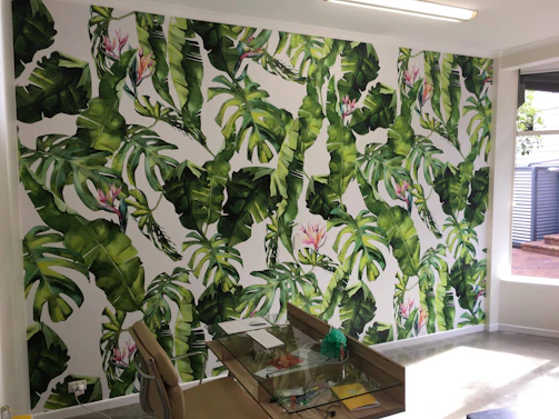 A bright, tropical-themed office reception area with fresh fruit decorations.