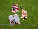 A vibrant outdoor picnic scene with colorful blankets and delicious snacks.