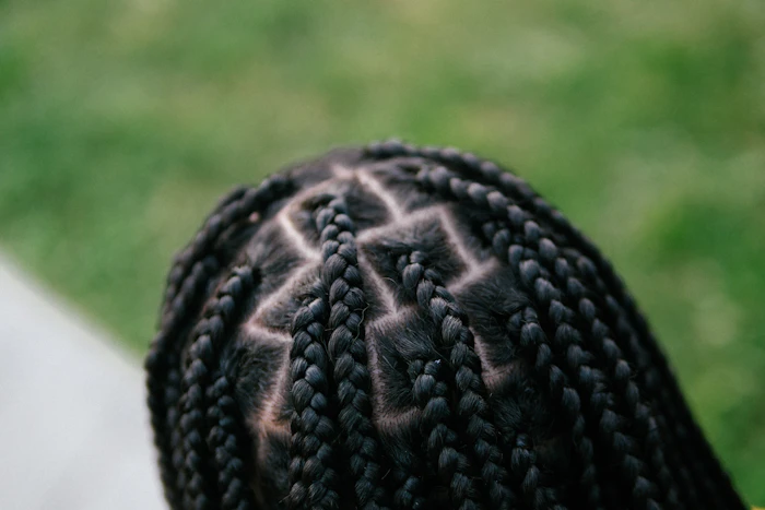 Intricate cornrow parting pattern, back of the head