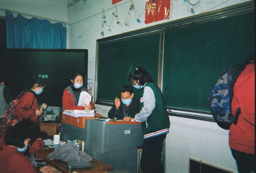 man in black and white jacket sitting beside woman in black and white jacket