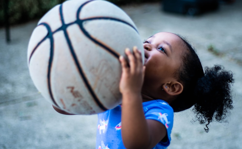 boy in blue and white crew neck t-shirt covering his mouth with his hand