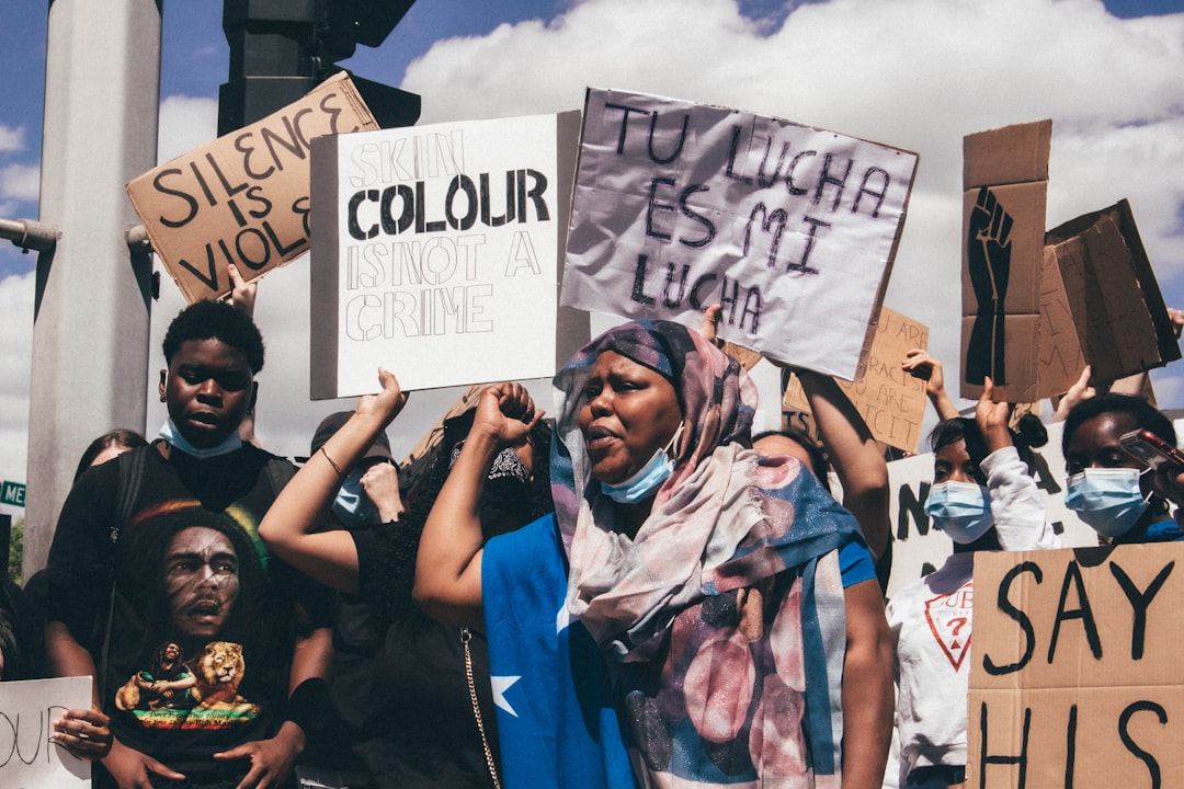 people holding white and black poster during daytime