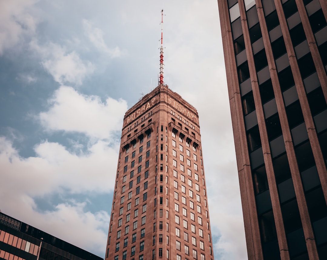 brown concrete building under gray clouds