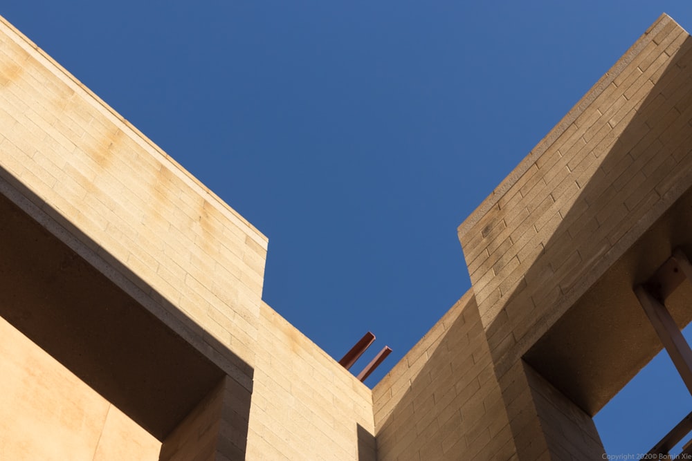 beige concrete building under blue sky during daytime