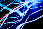 Motion graphics artist creating dynamic visuals with vibrant blue and orange highlights.
