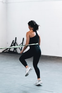 woman in black tank top and leggings doing exercise