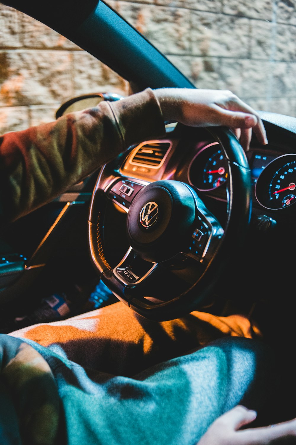 person in black leather jacket holding black steering wheel