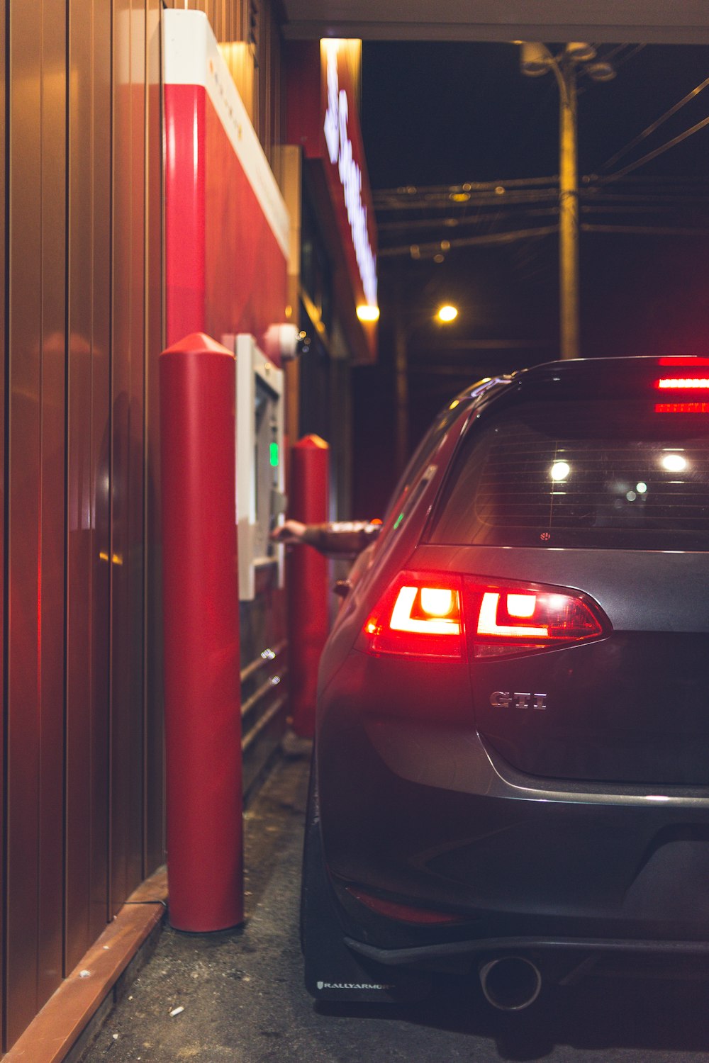 Black car in front of red lighted building photo – Free Automobile Image on  Unsplash