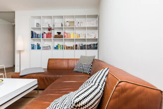 brown leather couch with throw pillows