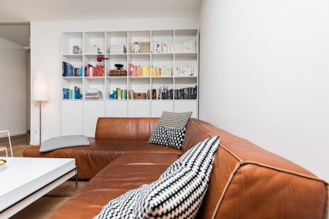 brown leather couch with throw pillows