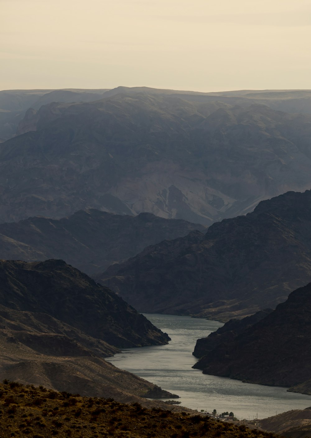 black and white mountains beside body of water during daytime