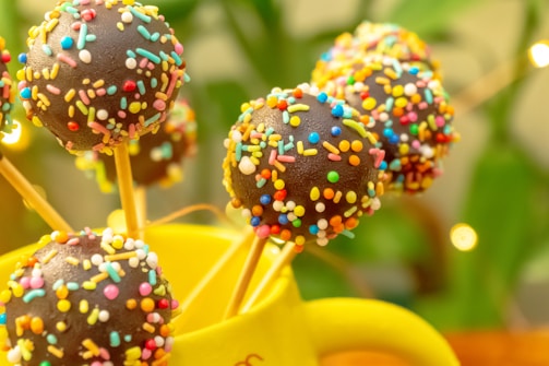 Artfully decorated cake pops featuring hand-painted designs.