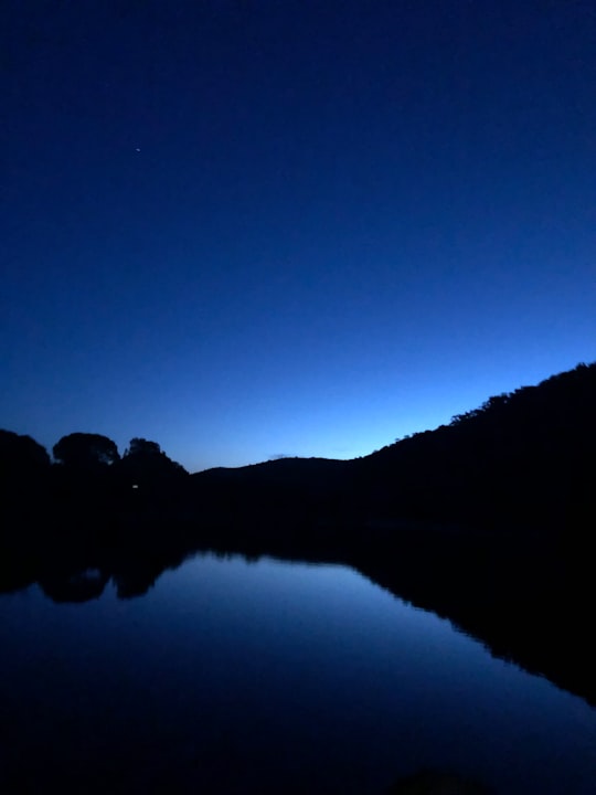 silhouette of mountain near body of water during night time in Wilsons Promontory VIC Australia