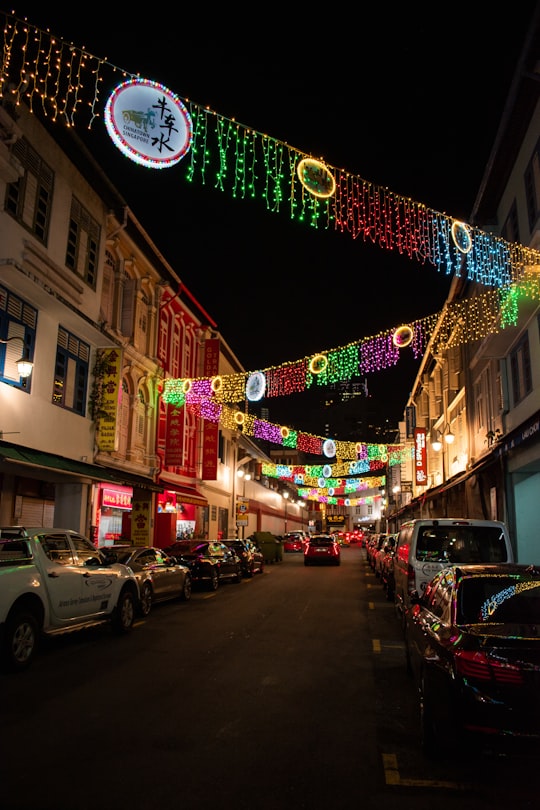 cars parked on street during night time in Chinatown Singapore