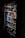 A vending machine filled with various snacks and beverages, including chips, chocolate bars, and canned drinks. The machine is dimly lit, highlighting the items inside through the clear glass panel.