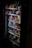 A vending machine filled with various snacks and beverages, including chips, chocolate bars, and canned drinks. The machine is dimly lit, highlighting the items inside through the clear glass panel.