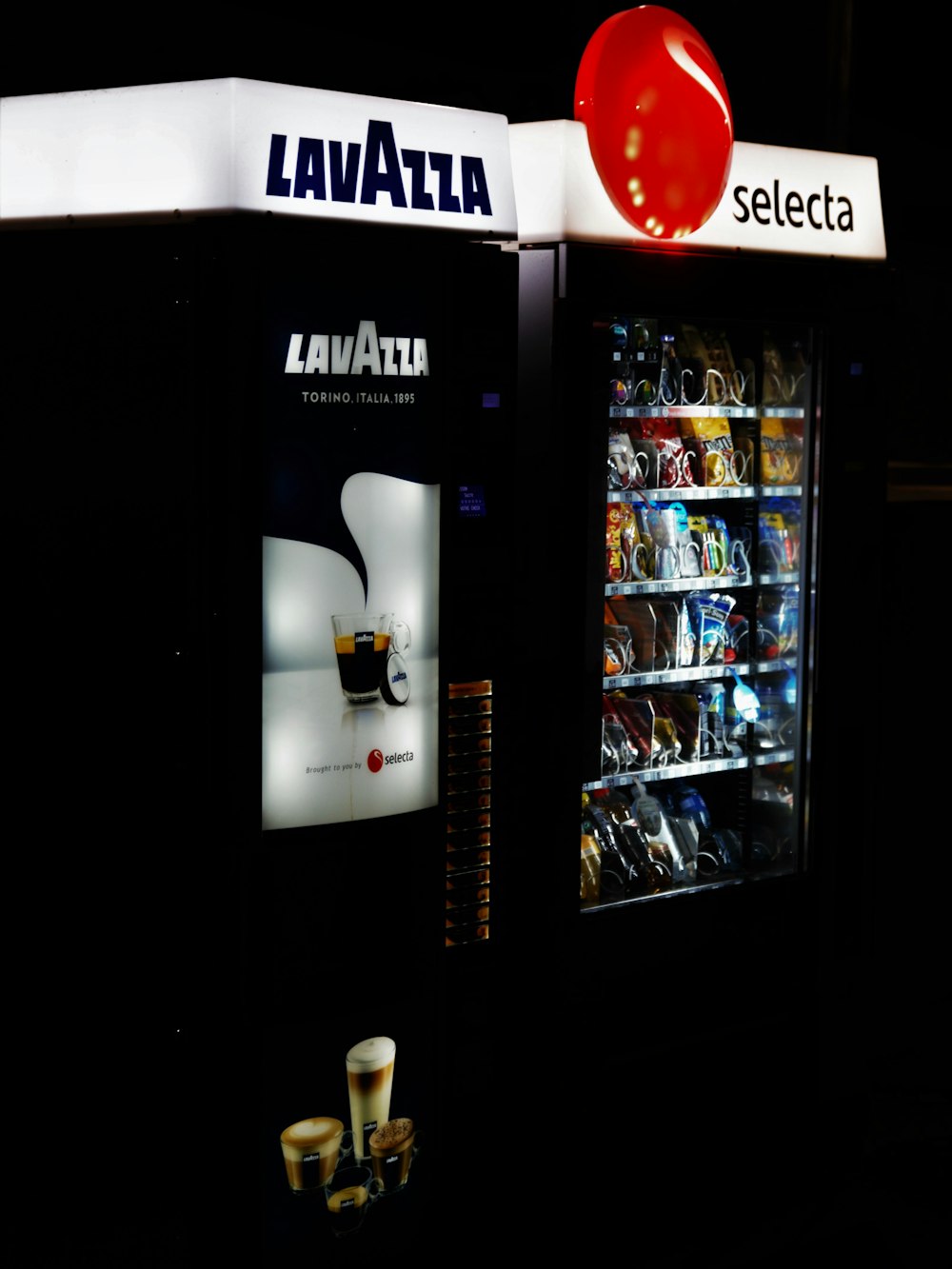 a vending machine is lit up at night