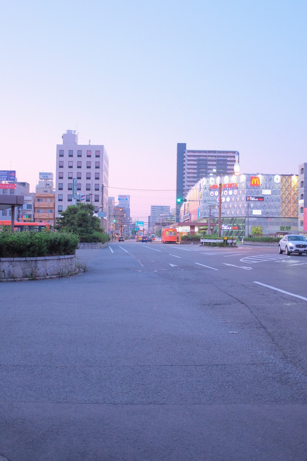 cars on road near high rise buildings during daytime