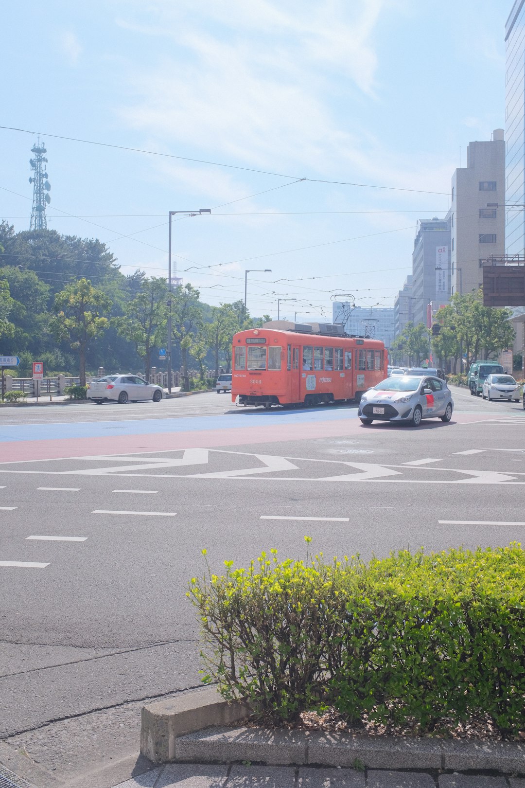 red bus on road during daytime