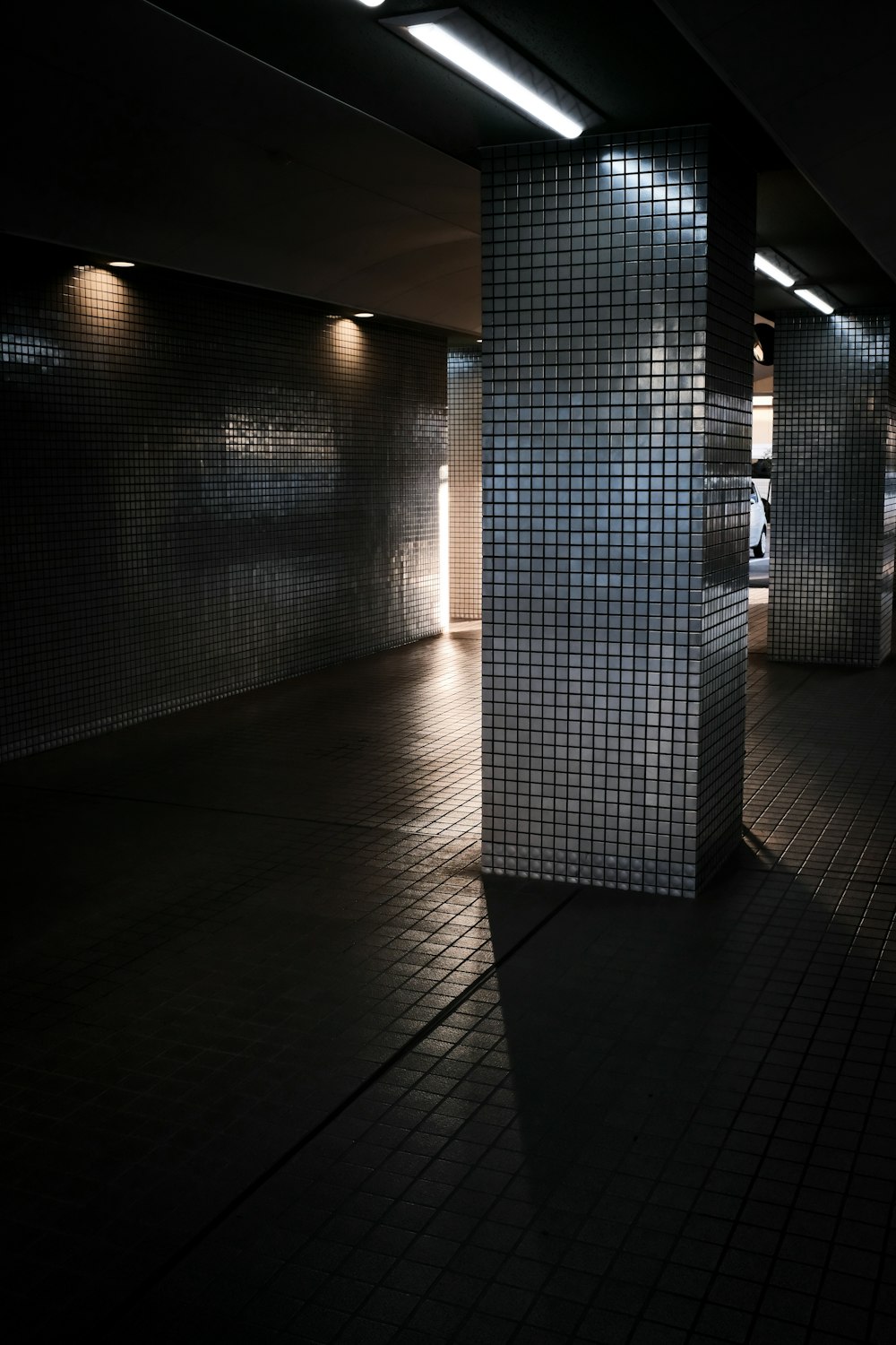 white and gray tiled hallway