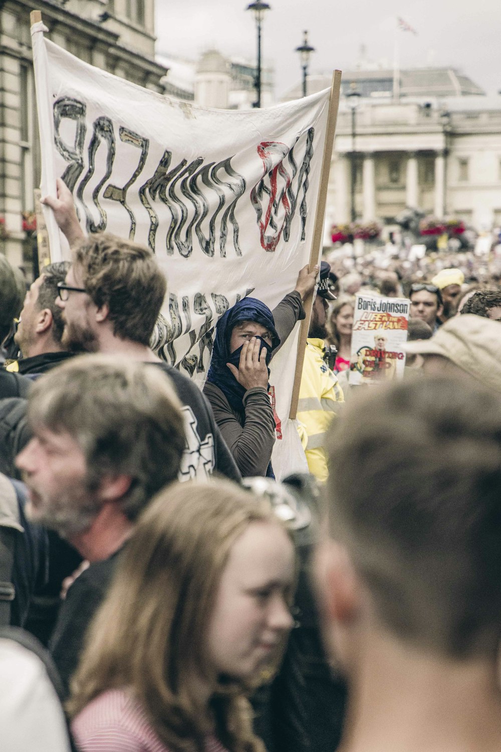 people gathering in a street during daytime