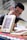 A person is sitting at a table, engaged with a book. The focus is on several books with a cover design featuring abstract art and the title 'Repassado'. The person appears to be reading, creating a scholarly or contemplative atmosphere.