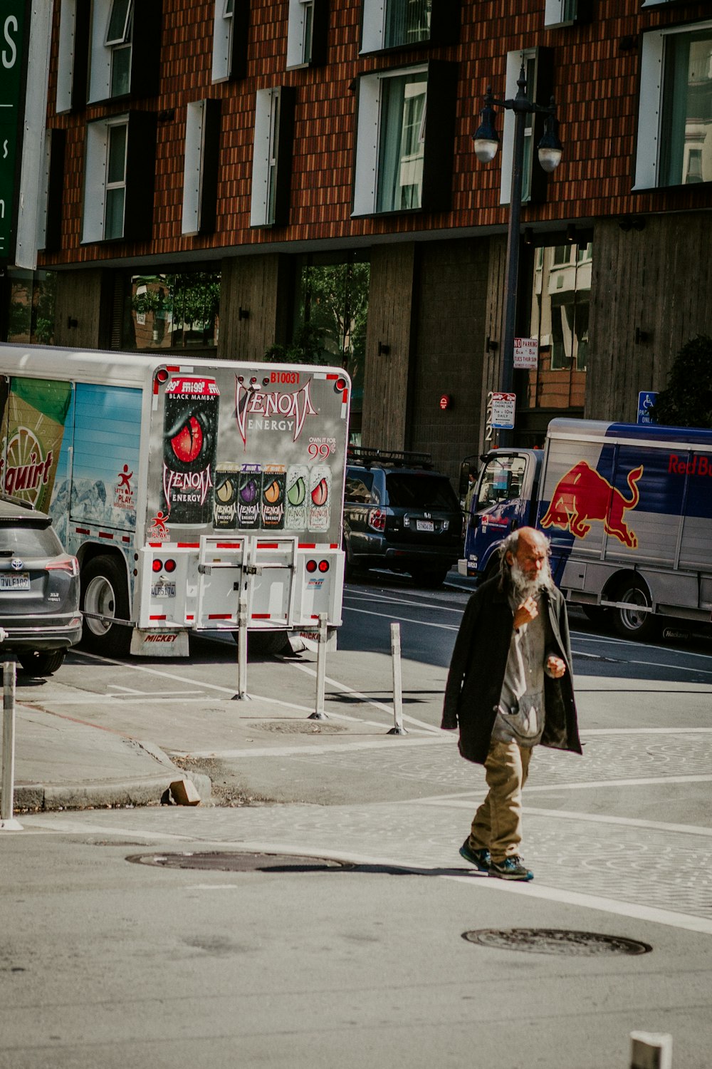 woman in black coat walking on sidewalk during daytime