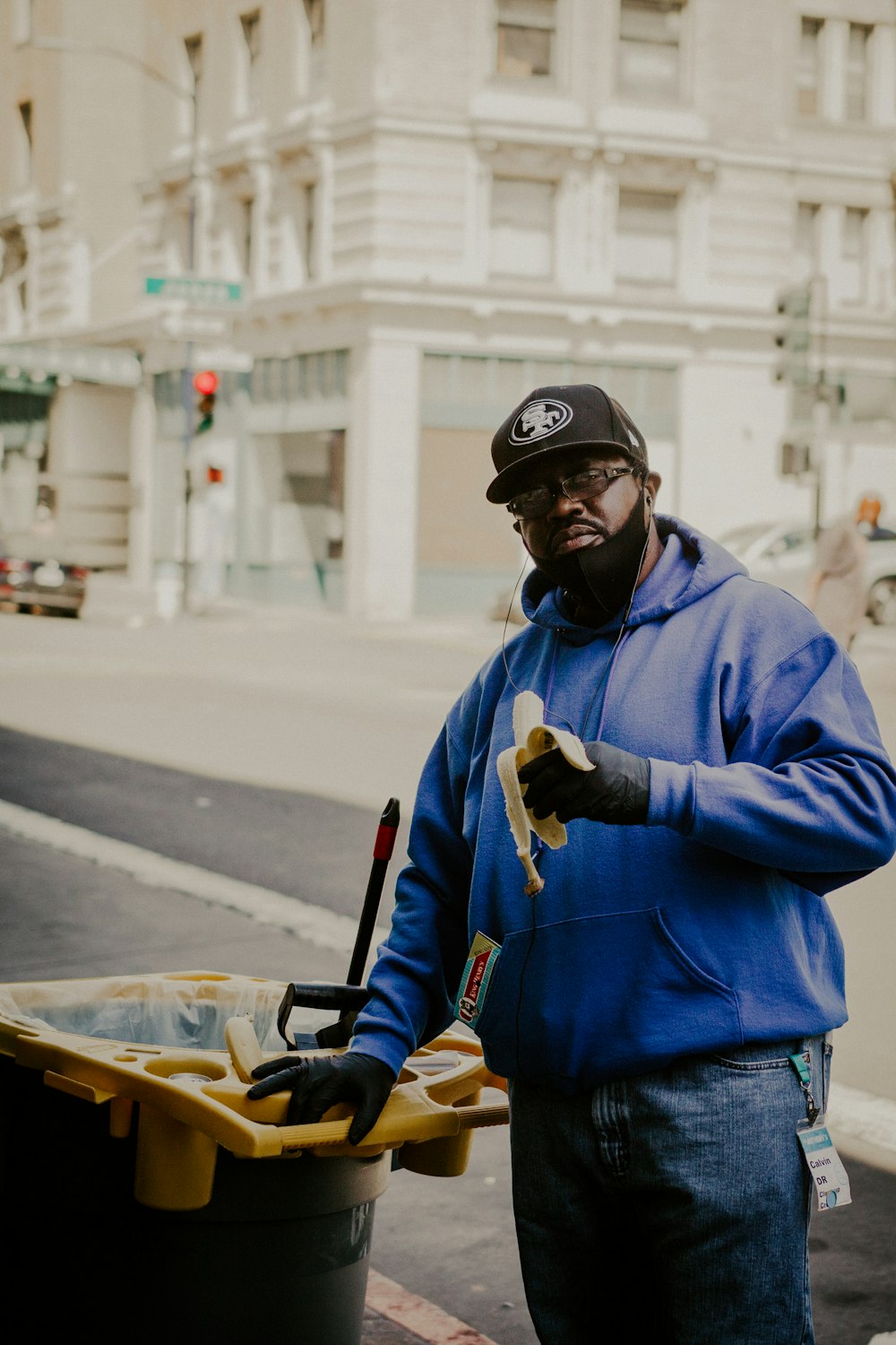 man in blue jacket and black helmet holding black and yellow skateboard