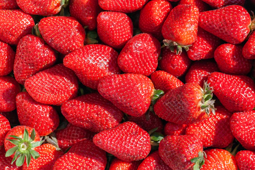 red strawberries on green leaves