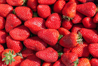 red strawberries on green leaves
