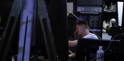 A thoughtful director reviewing storyboards in a dimly lit studio.