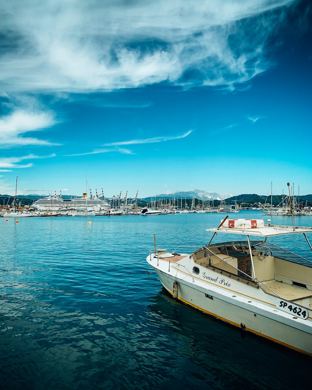 white boat on sea under blue sky during daytime