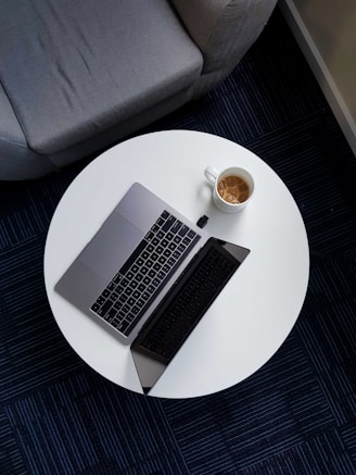 macbook pro on white round table