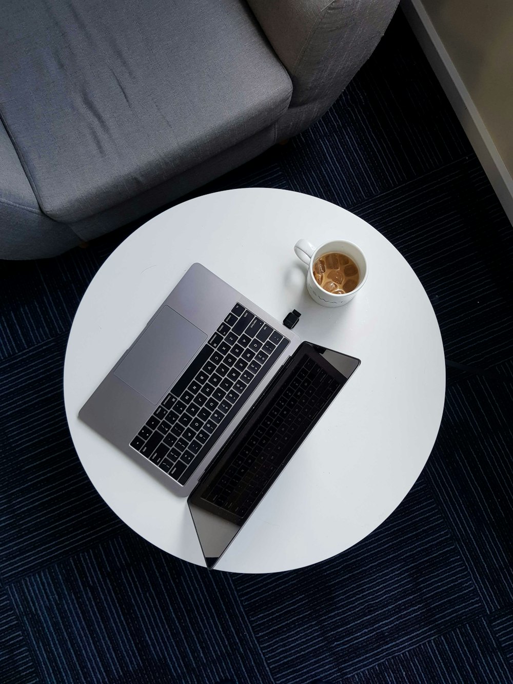 macbook pro on white round table