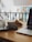 A cozy workspace with a laptop and coffee cup on a wooden desk.