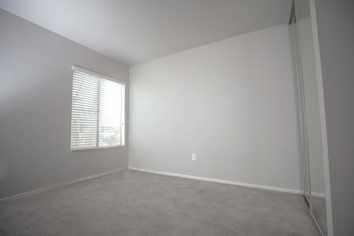 Bare bedroom wall and window with nothing fitted