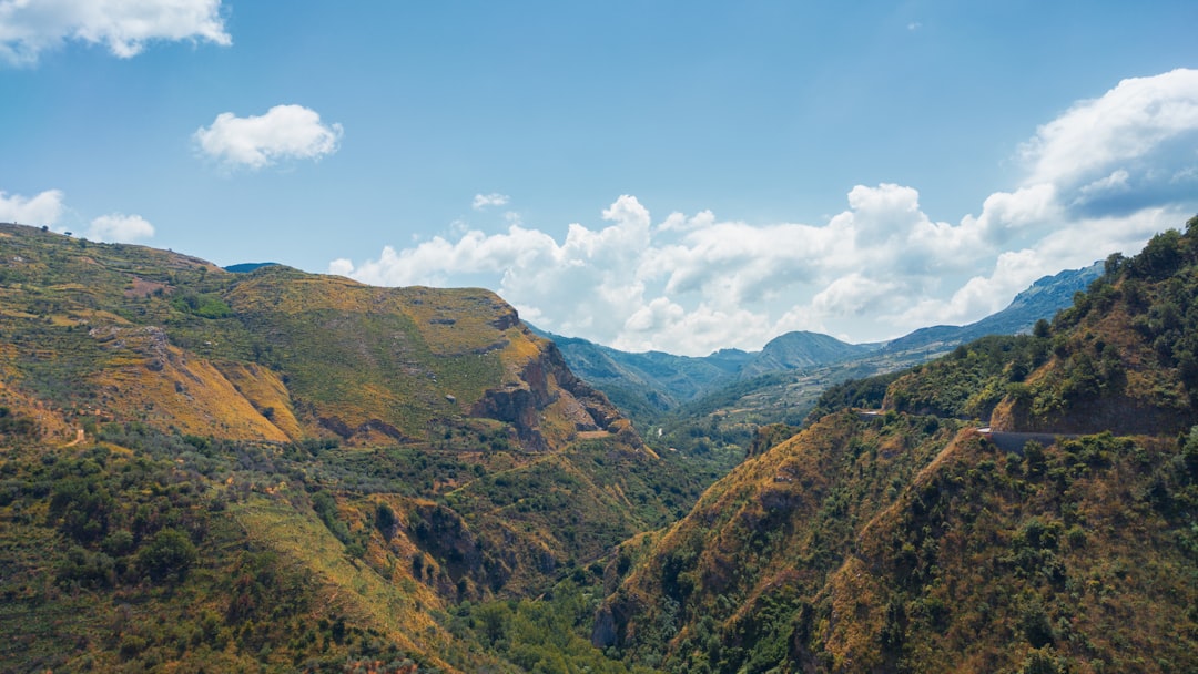 green and brown mountains under blue sky during daytime