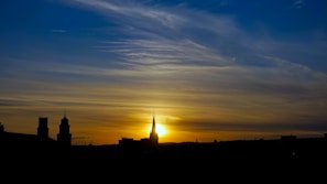 A sunset behind the skyline, symbolizing the end of a news day