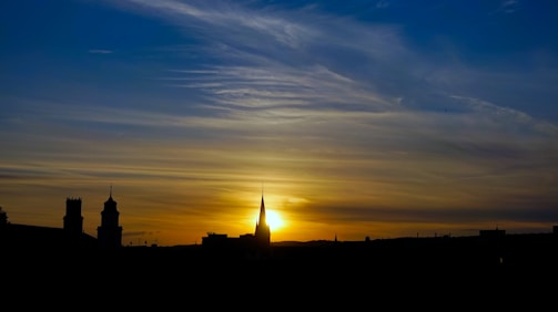 Sunset over a city skyline symbolizing progress and hope.