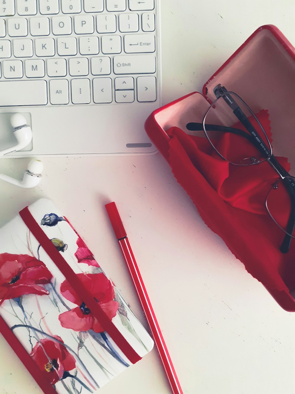 red framed eyeglasses on white laptop computer