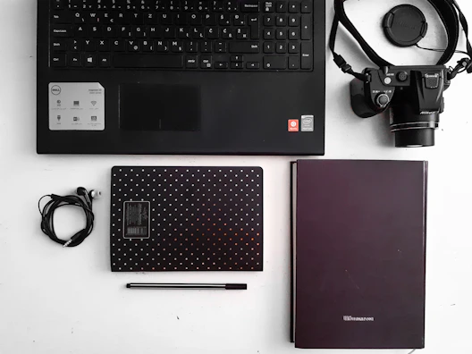 An artistic flat lay of tech gear and notes used for planning upcoming HVAC.you videos.